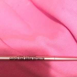 Too faced super fine brow detailer ultra slim brow pencil in medium brown.